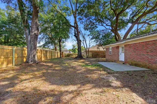 a view of a yard with a tree