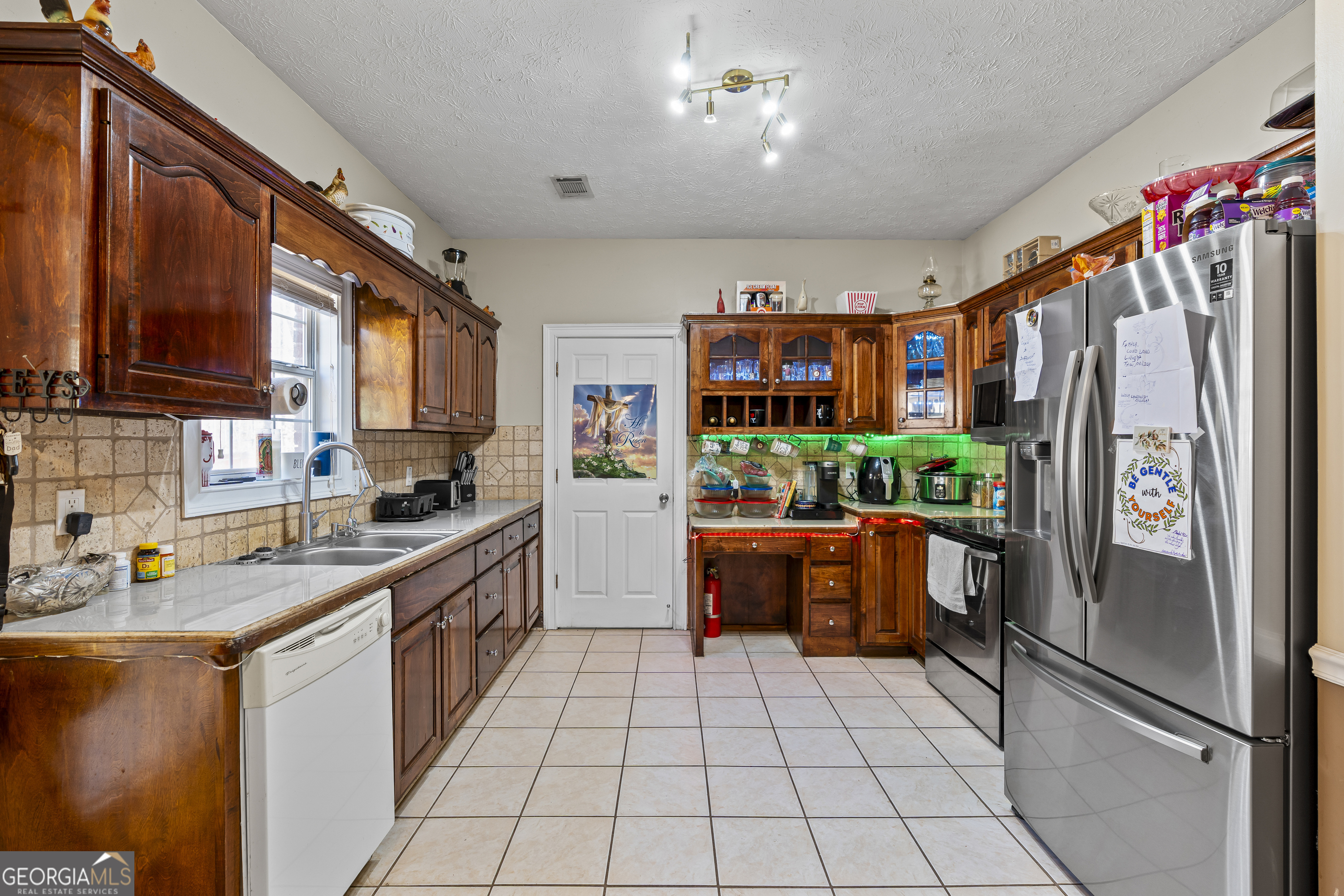 2498 Highway 212 Covington, GA 30016 - Photo 13 of 74 a kitchen with stainless steel appliances granite countertop a refrigerator a sink dishwasher stove and oven