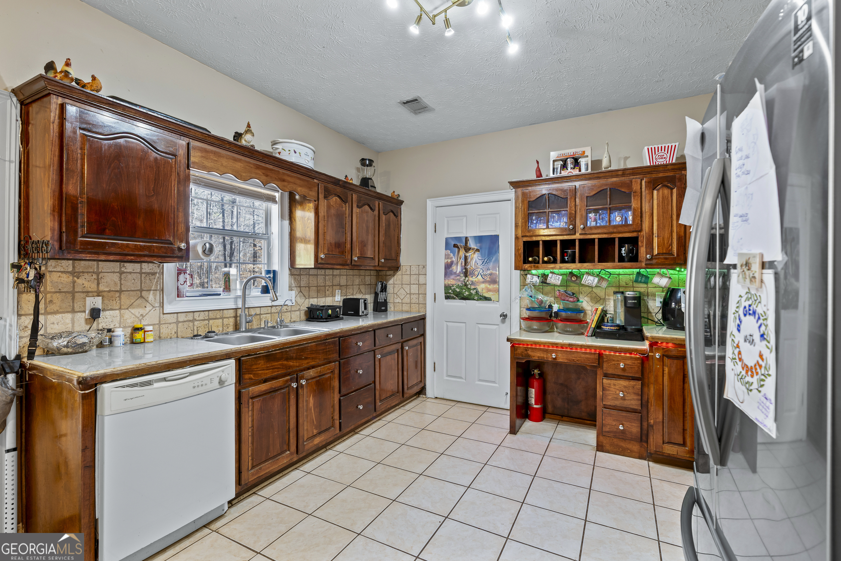 2498 Highway 212 Covington, GA 30016 - Photo 14 of 74 a kitchen with stainless steel appliances a sink and a refrigerator