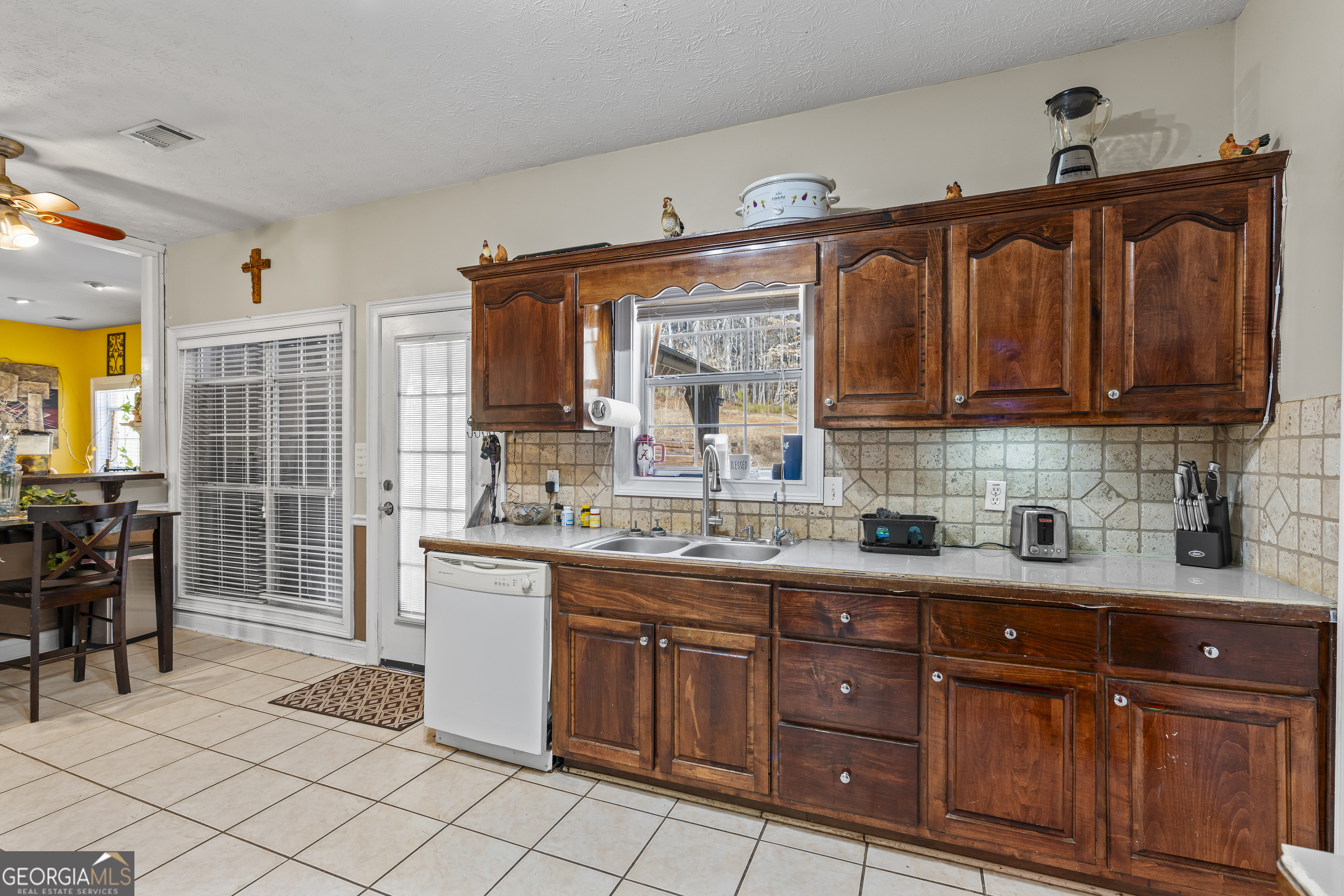 2498 Highway 212 Covington, GA 30016 - Photo 15 of 74 a kitchen with granite countertop a sink and cabinets