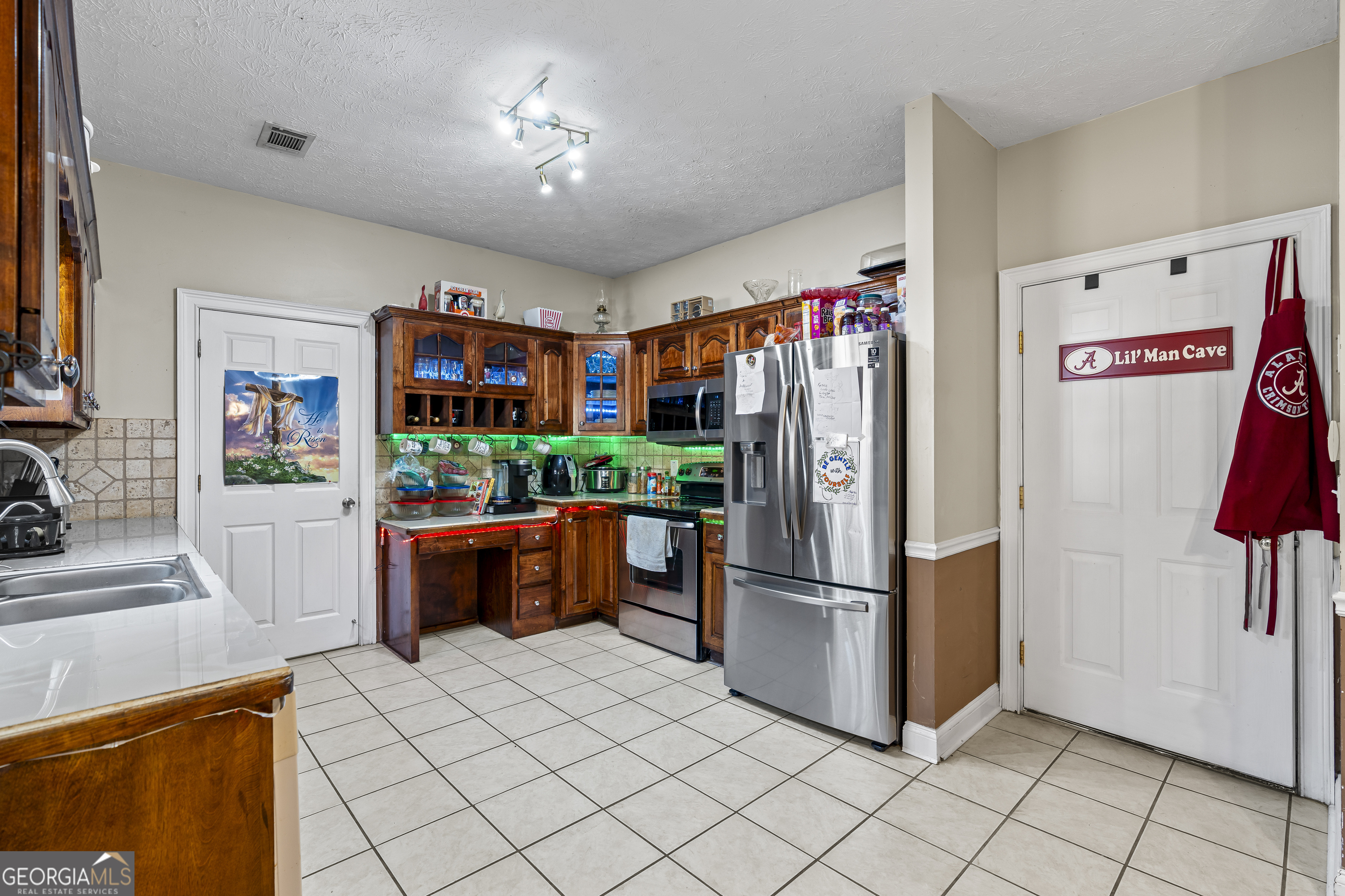 2498 Highway 212 Covington, GA 30016 - Photo 17 of 74 a kitchen with stainless steel appliances granite countertop a refrigerator and a sink