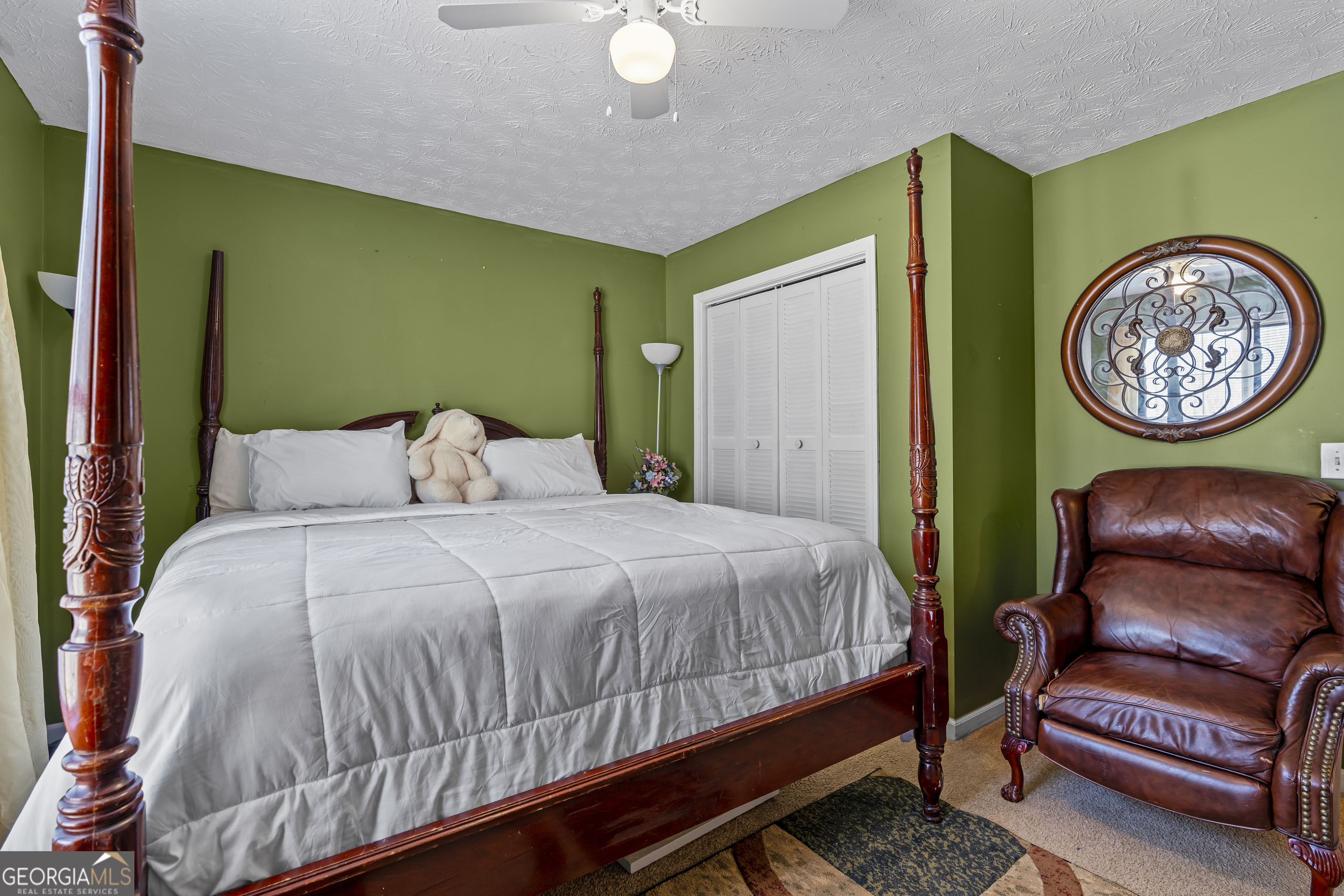 2498 Highway 212 Covington, GA 30016 - Photo 38 of 74 a bedroom with a bed and a chair with potted plant