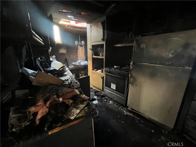 a room with water heater and wooden cabinets
