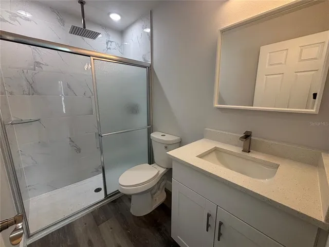 a bathroom with a sink toilet and shower