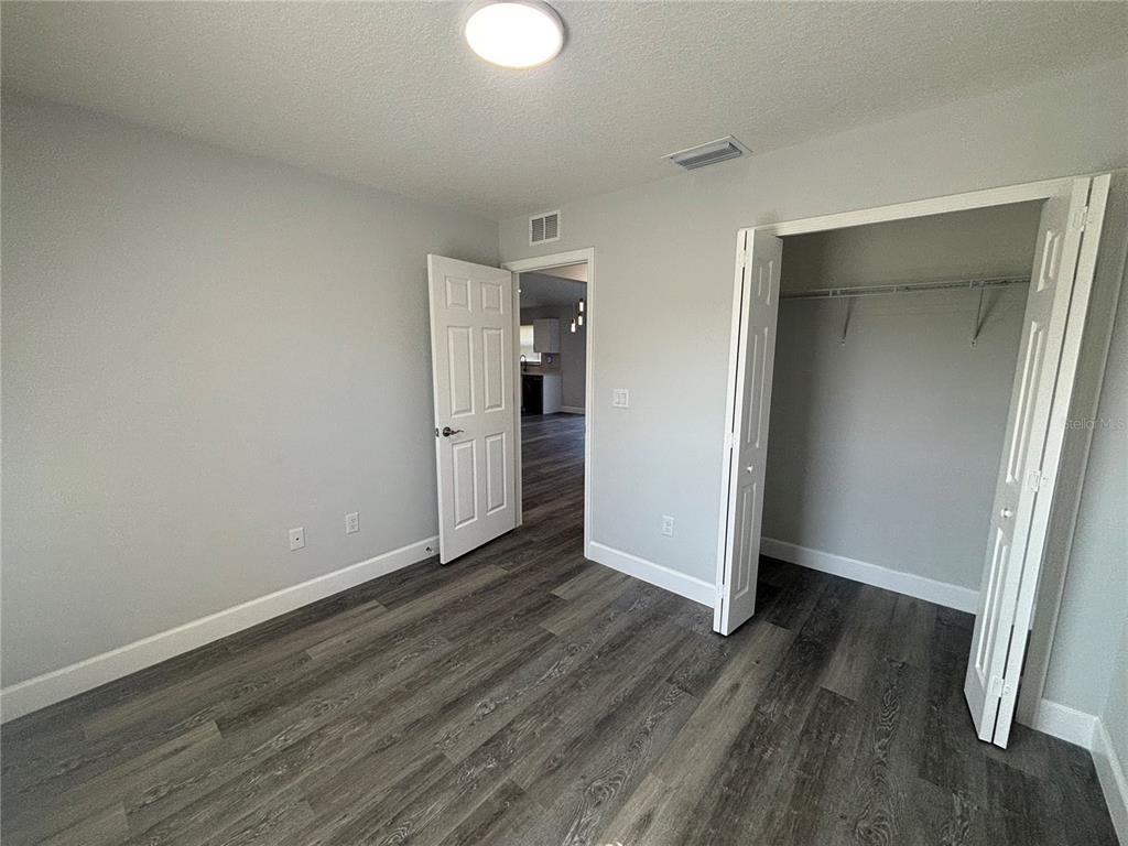 13187 Southwest 103rd Place Dunnellon, FL 34432 - Photo 13 of 24 an empty room with wooden floor and closet