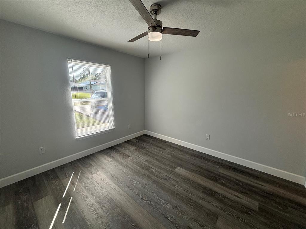 13187 Southwest 103rd Place Dunnellon, FL 34432 - Photo 19 of 24 wooden floor in an empty room with a window