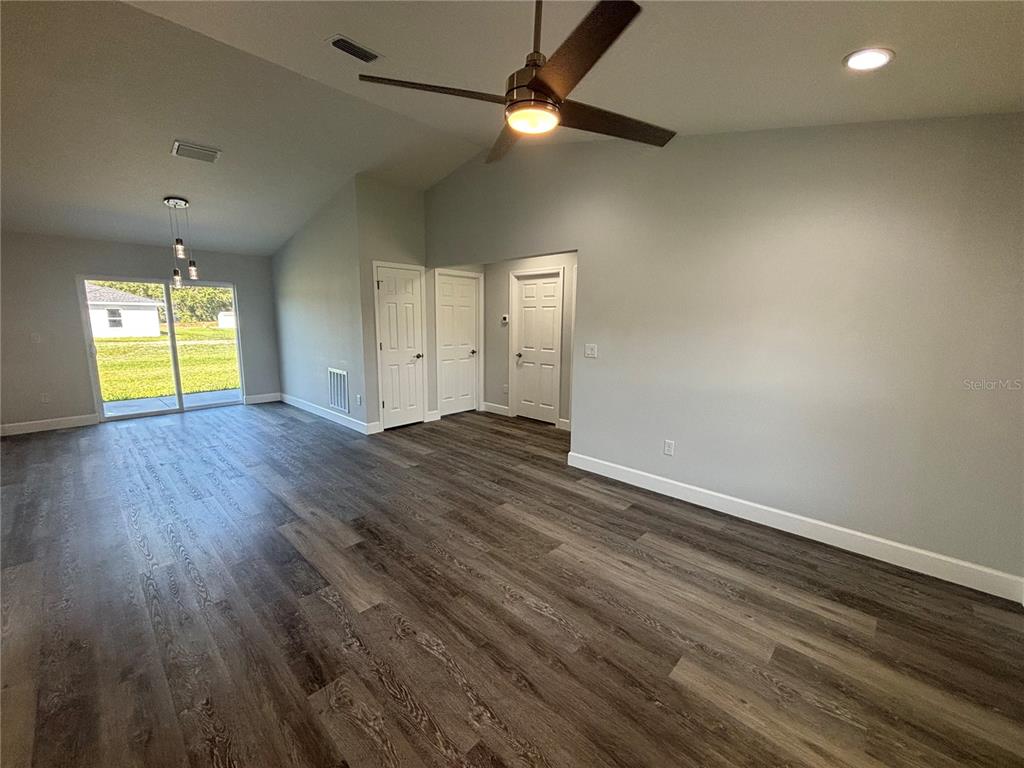 13187 Southwest 103rd Place Dunnellon, FL 34432 - Photo 4 of 24 an empty room with wooden floor and windows