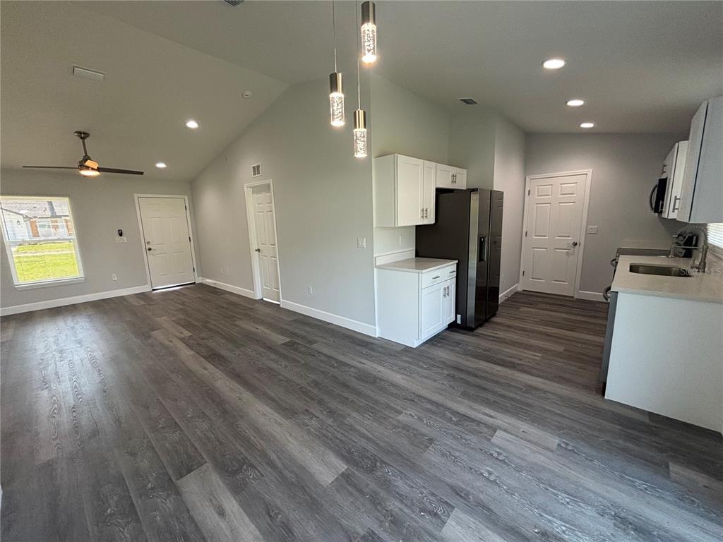 13187 Southwest 103rd Place Dunnellon, FL 34432 - Photo 5 of 24 a view of a kitchen center island cabinets and stainless steel appliances