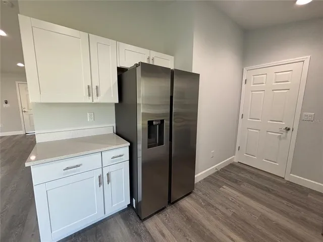 a kitchen with a refrigerator sink and cabinets