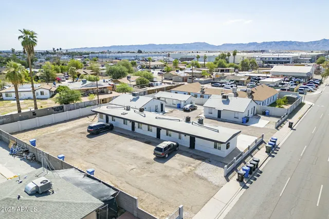 a view of city and patio with a table and chairs