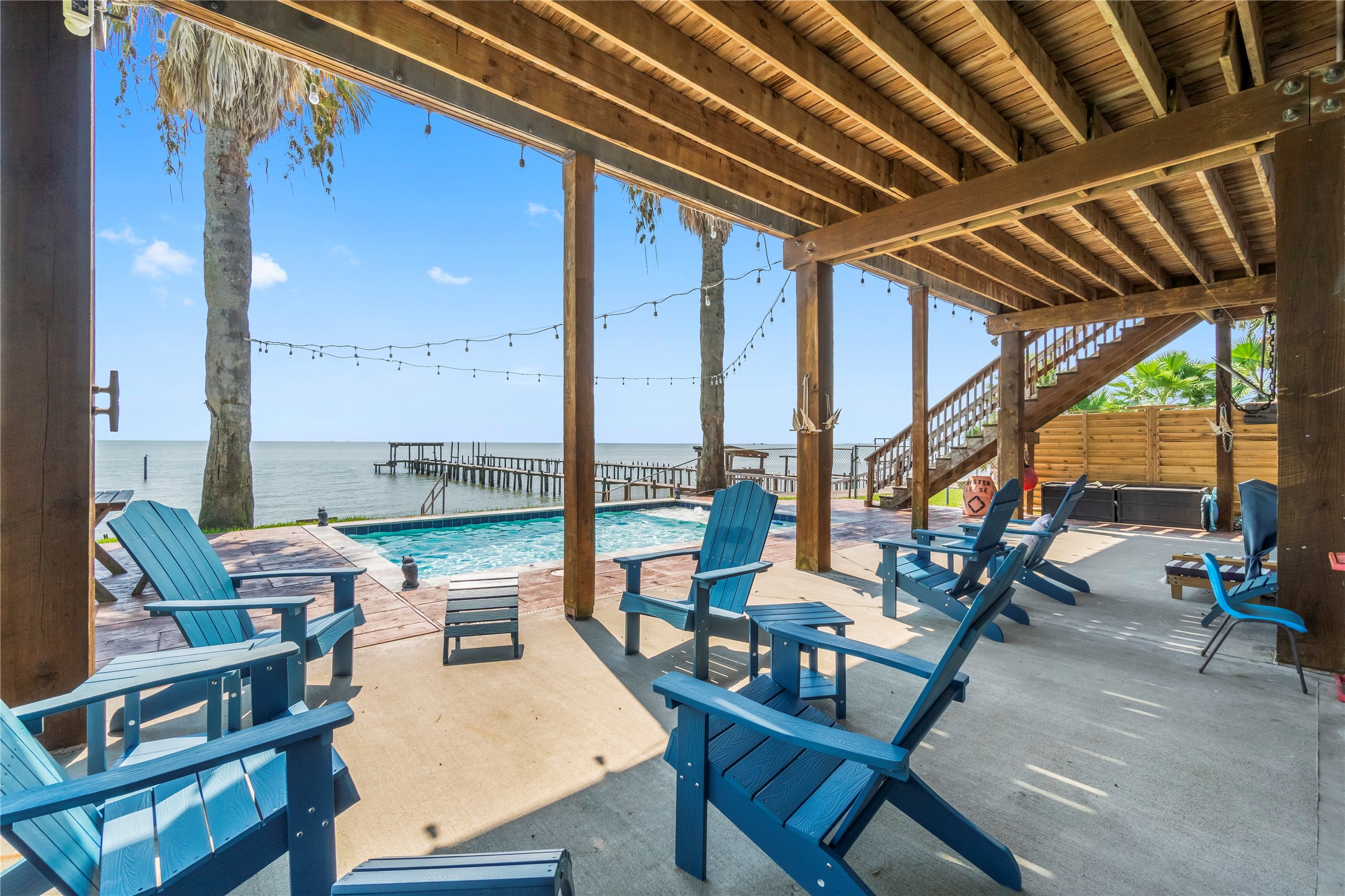 427 2nd Street San Leon, TX 77539 - Photo 14 of 30 a roof deck with table and chairs and couches with wooden floor