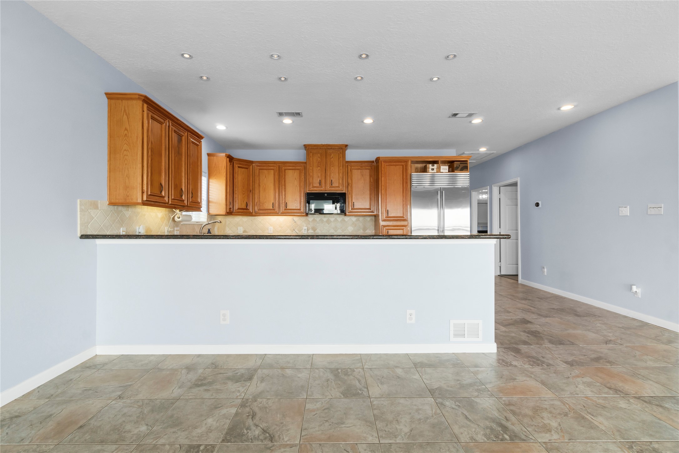 427 2nd Street San Leon, TX 77539 - Photo 15 of 30 a view of kitchen with kitchen island granite countertop a stove top oven a sink and a granite counter top
