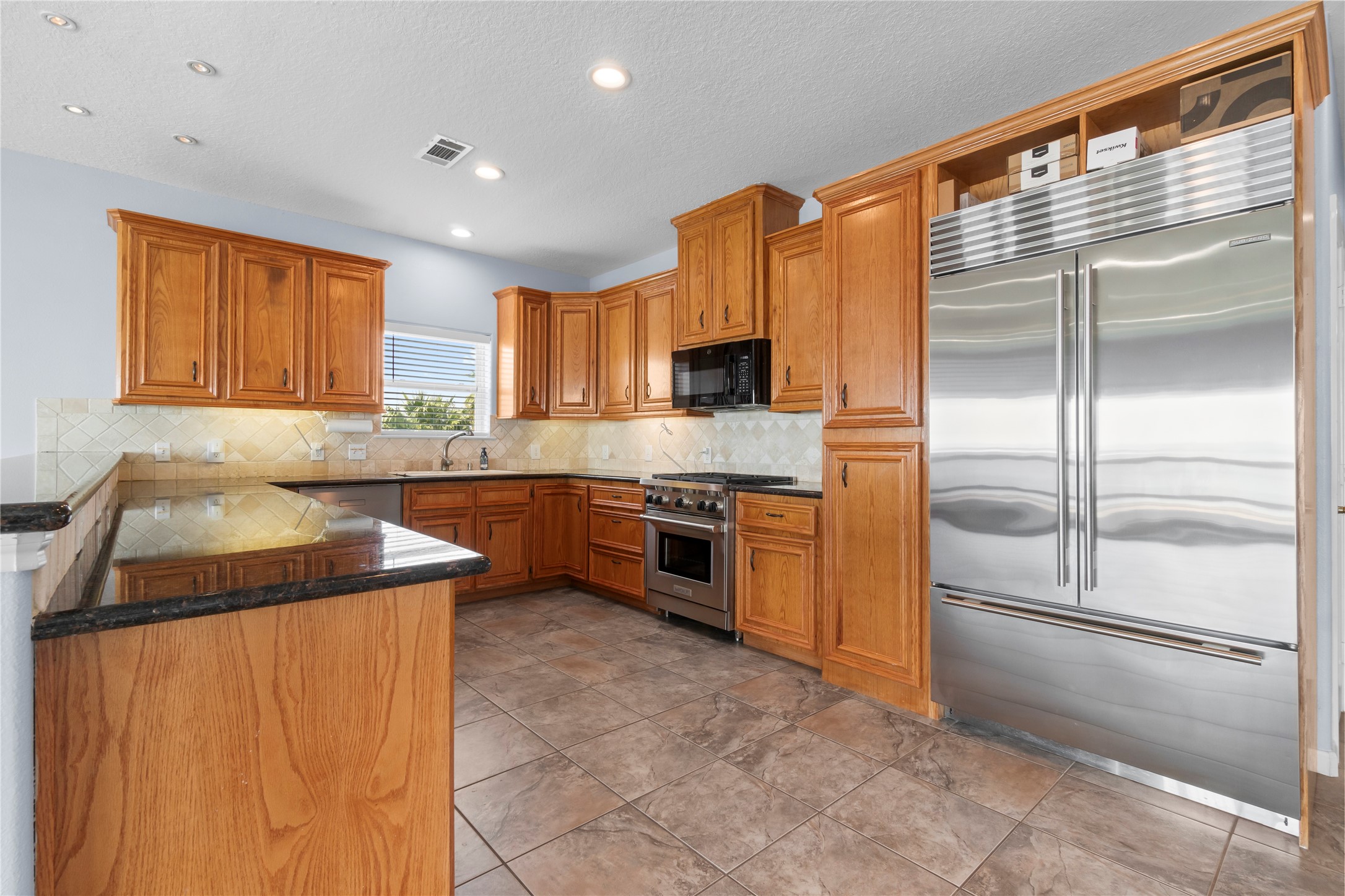 427 2nd Street San Leon, TX 77539 - Photo 16 of 30 a kitchen with a refrigerator a sink and a stove