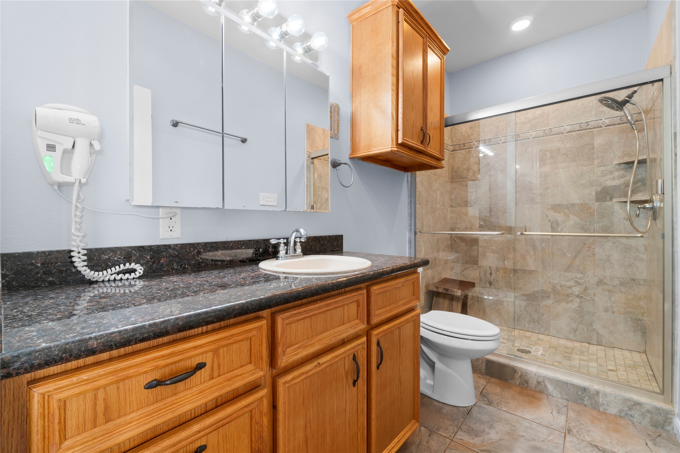 427 2nd Street San Leon, TX 77539 - Photo 20 of 30 a bathroom with a granite countertop sink a toilet and bathtub