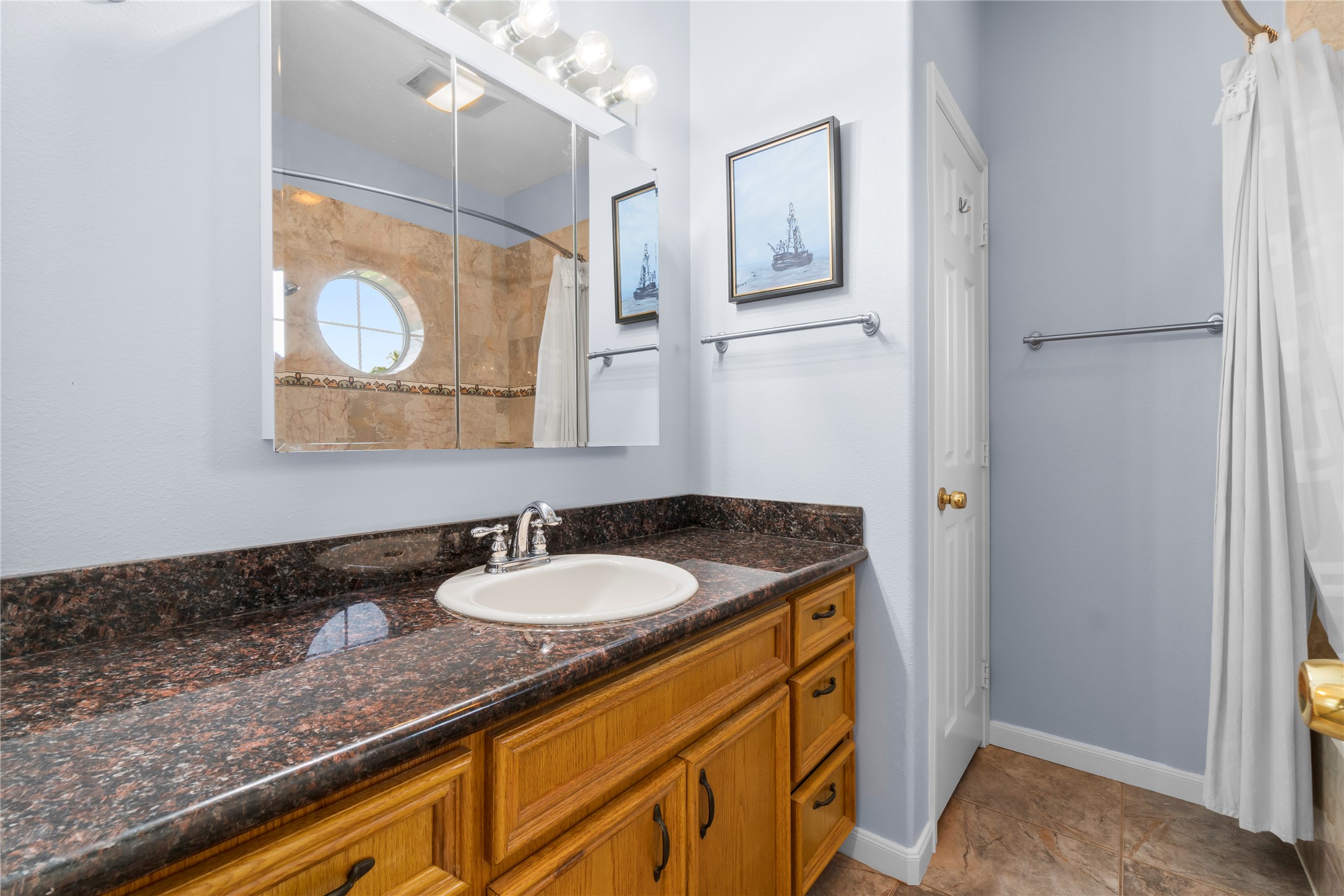 427 2nd Street San Leon, TX 77539 - Photo 21 of 30 a bathroom with a granite countertop sink and a mirror