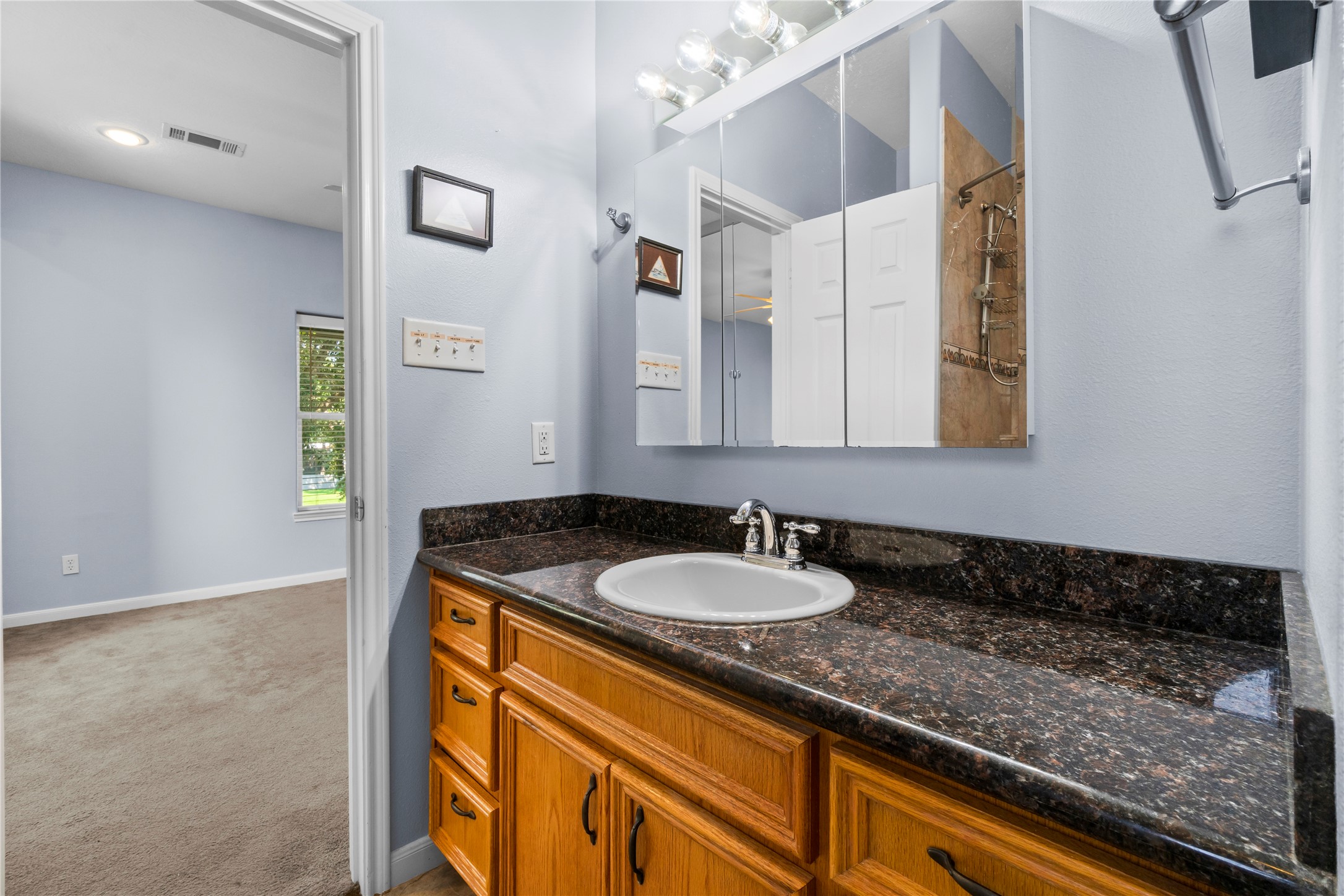 427 2nd Street San Leon, TX 77539 - Photo 23 of 30 a bathroom with a granite countertop sink and a mirror