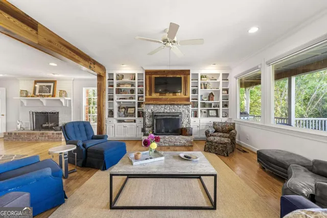 a living room with furniture kitchen view and a chandelier