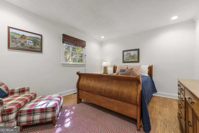 a view of a house with a deck and a large window with wooden floor