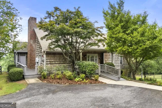 front view of a house with a tree