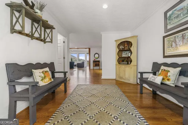 a living room with furniture a fireplace and a chandelier