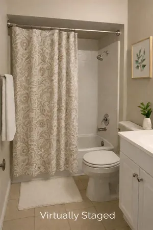a bathroom with a toilet and a shower curtain