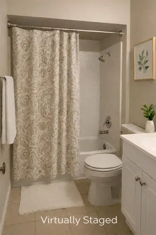 a bathroom with a toilet and a shower curtain