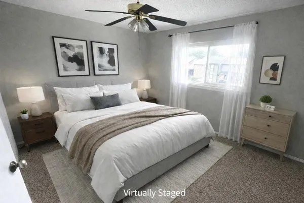 a bedroom with a bed and a window