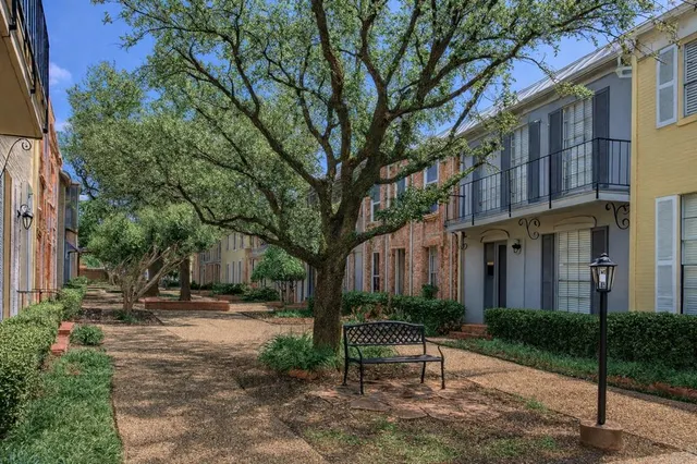 a view of a chair and table in backyard of house