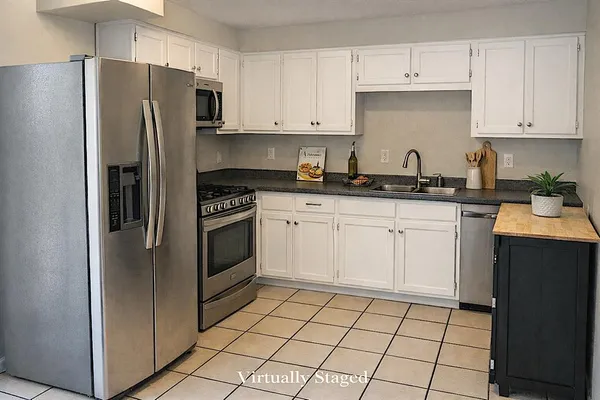 a kitchen with a sink a stove and refrigerator