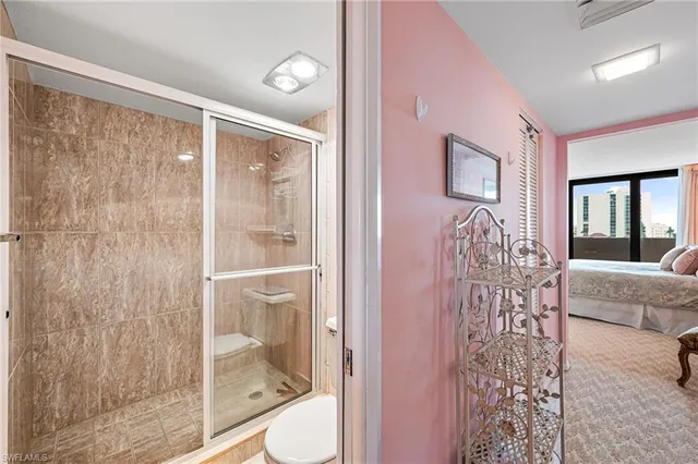 a bathroom with a glass shower door and a sink