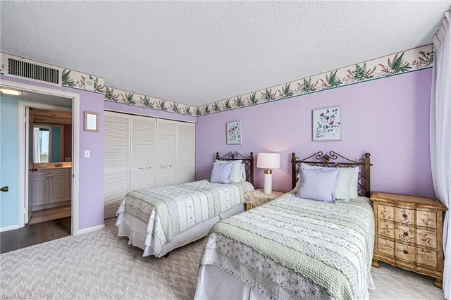 a bedroom with two beds and painted walls