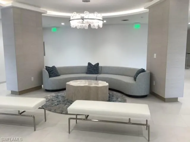a living room with furniture chandelier and a chandelier