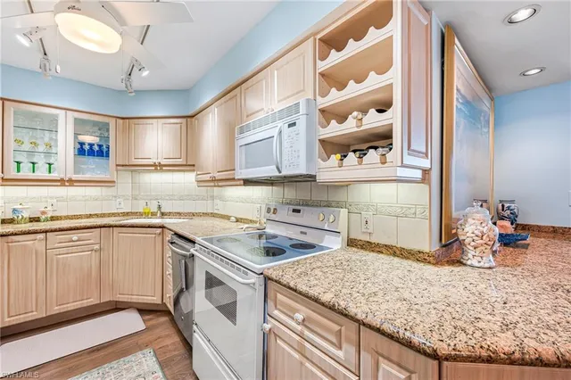 a kitchen with a sink stove and cabinets