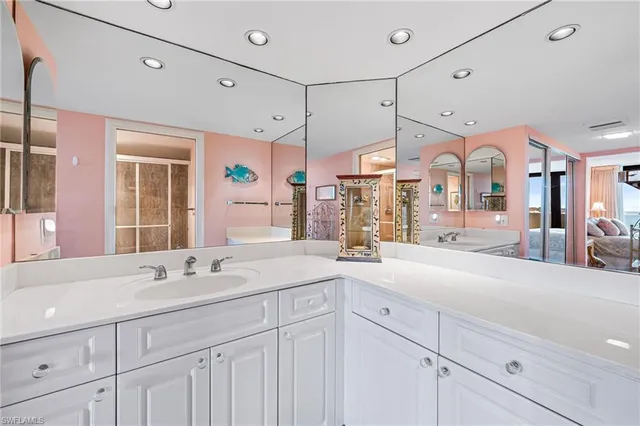 a spacious bathroom with a sink a mirror and a shower