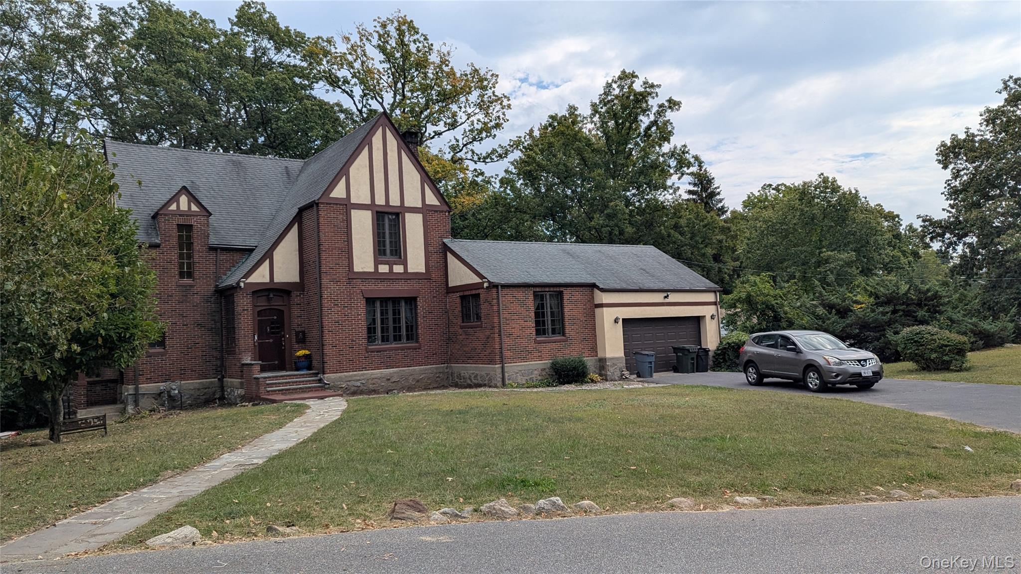 a car parked in front of house with a yard