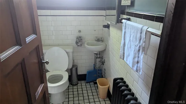 a white toilet sitting next to a shower curtain
