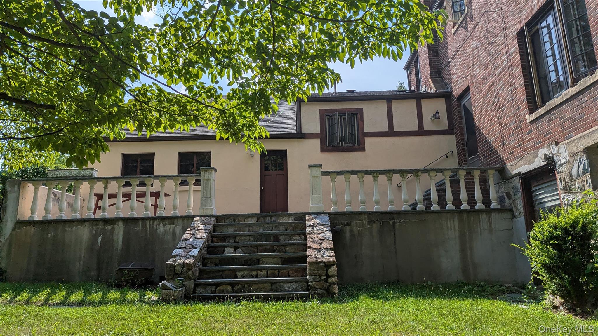 78 Roe Avenue Highland Falls, NY 10928 - Photo 2 of 41 a front view of a house with a garden and tree