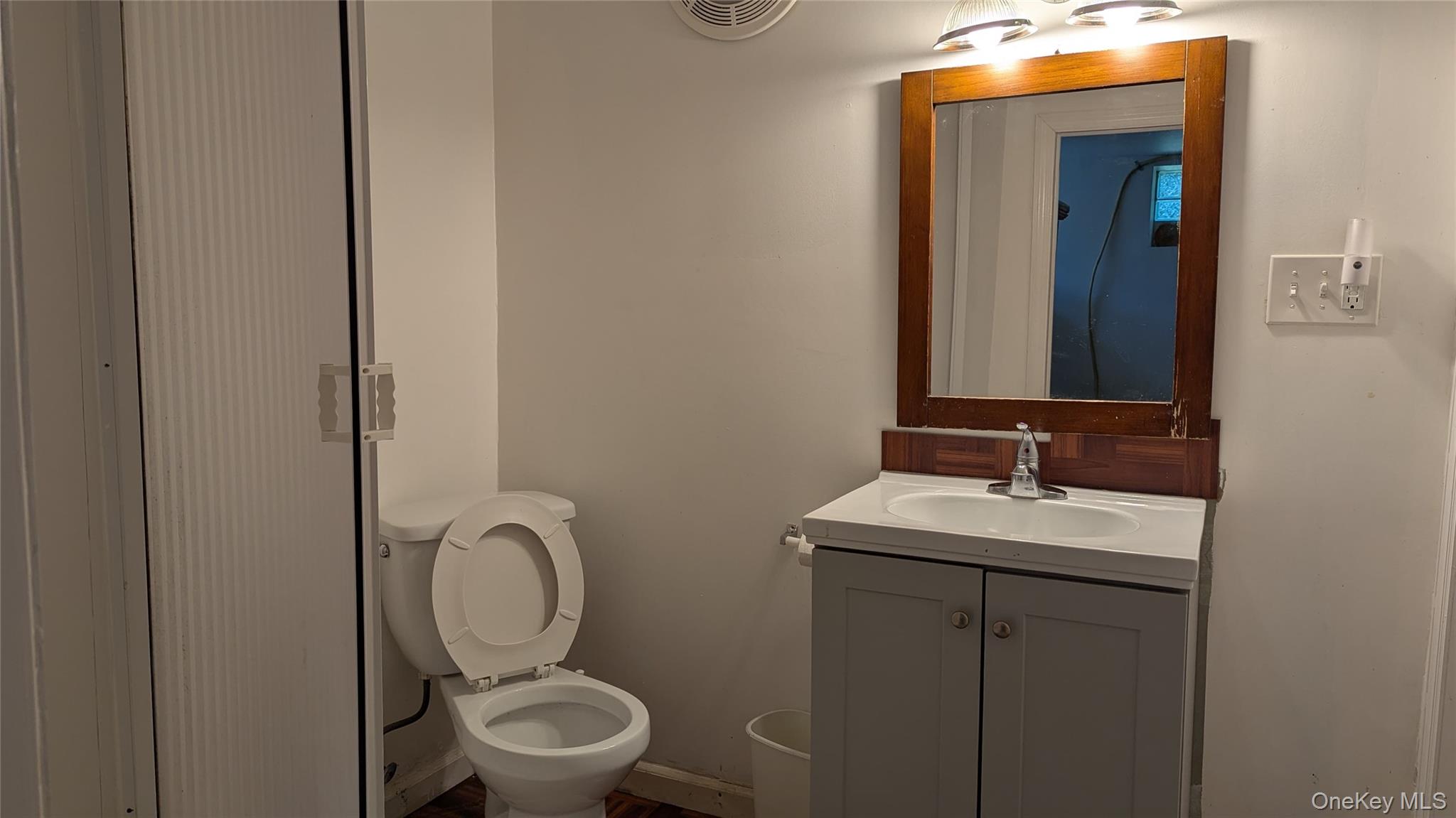 78 Roe Avenue Highland Falls, NY 10928 - Photo 32 of 41 a bathroom with a toilet a sink and mirror