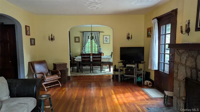 a living room with furniture a dining table and a fireplace