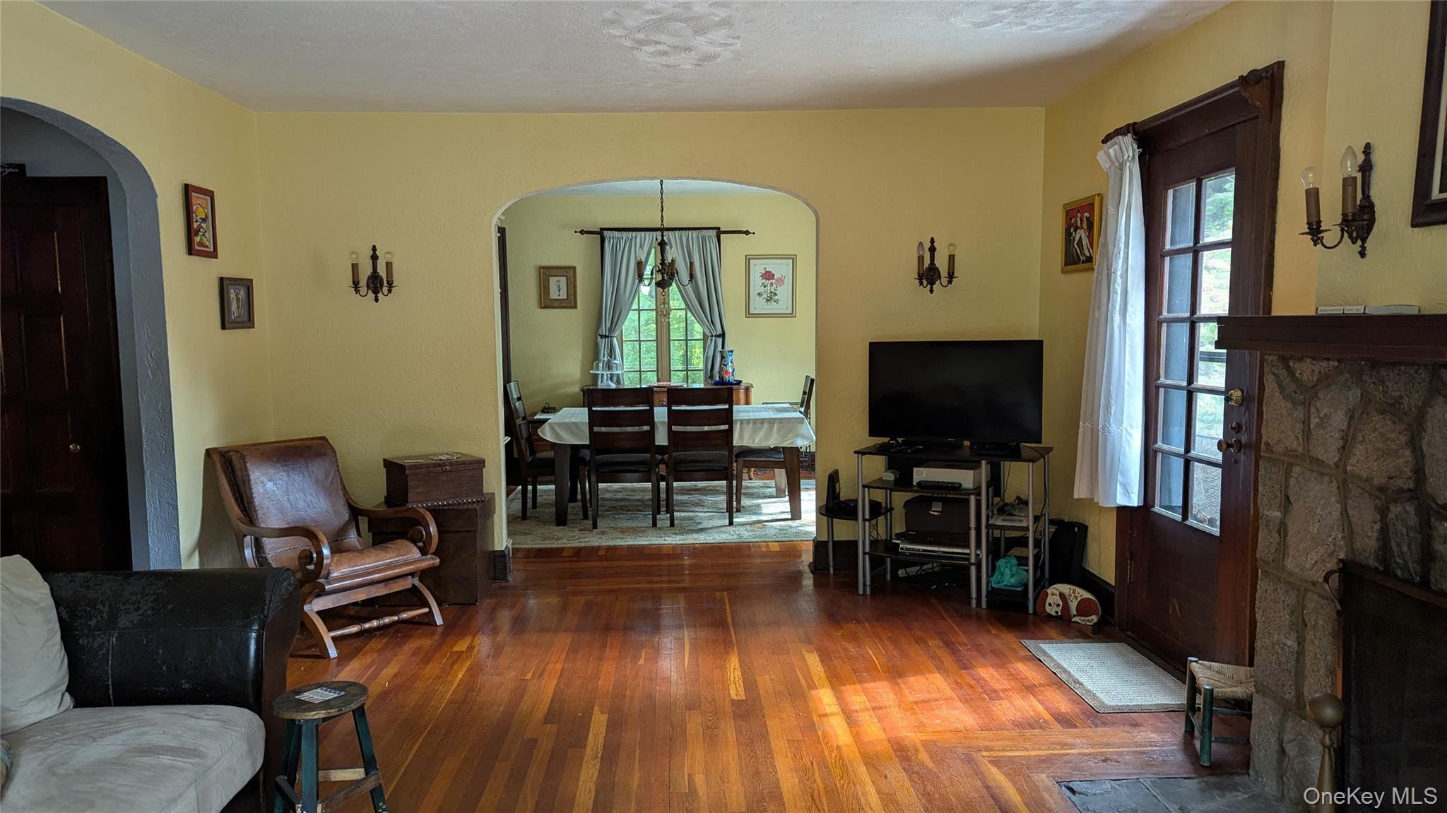78 Roe Avenue Highland Falls, NY 10928 - Photo 9 of 41 a living room with furniture a dining table and a fireplace