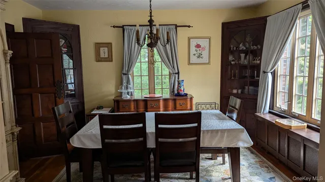 a view of a dining room with furniture and a window