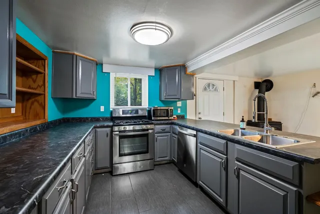 an empty room with wooden floor and window