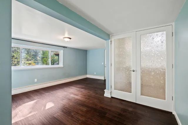 a view of empty room with wooden walls