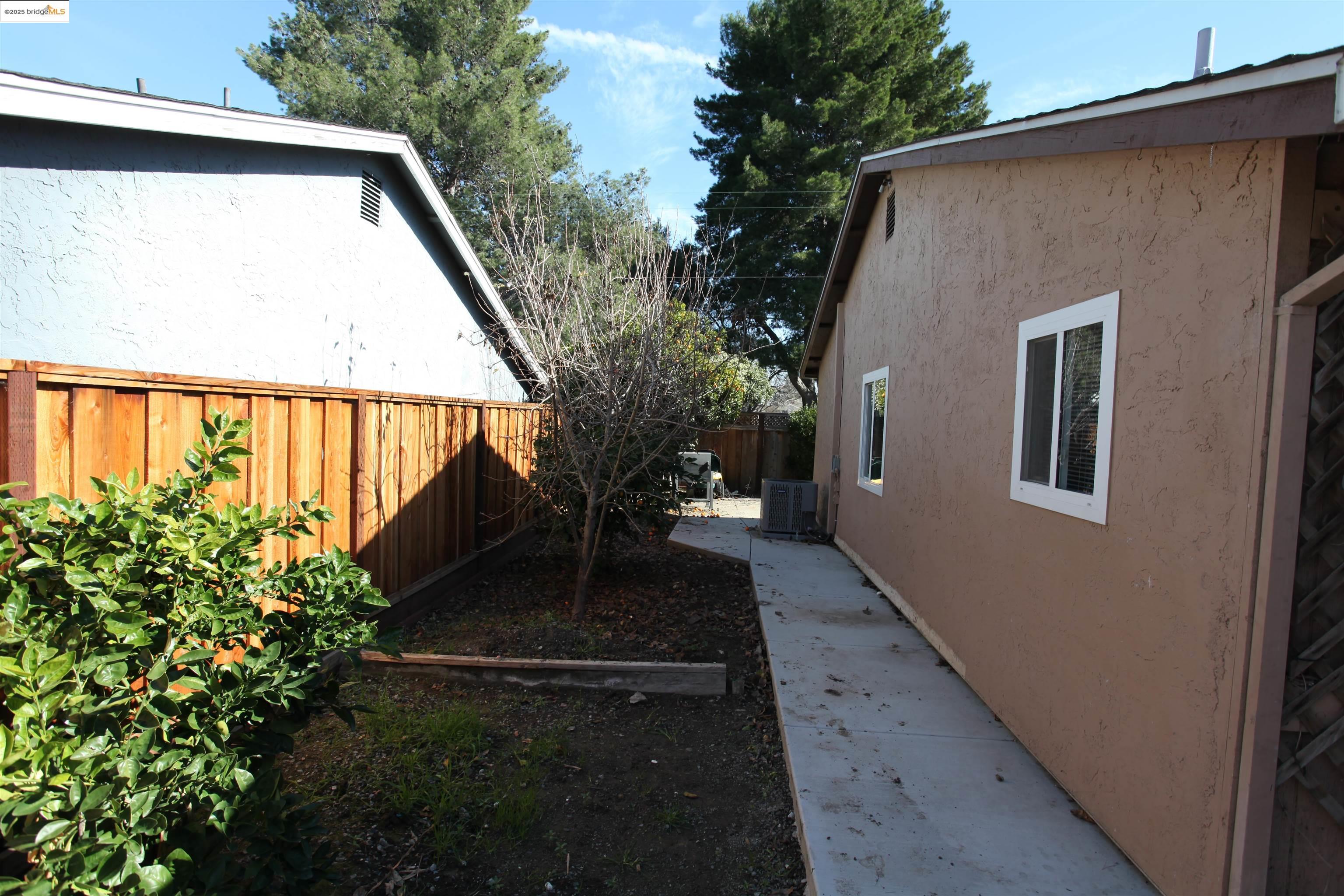 3044 Winterbrook Drive Bay Point, CA 94565 - Photo 18 of 18 a view of backyard with plants and wooden fence