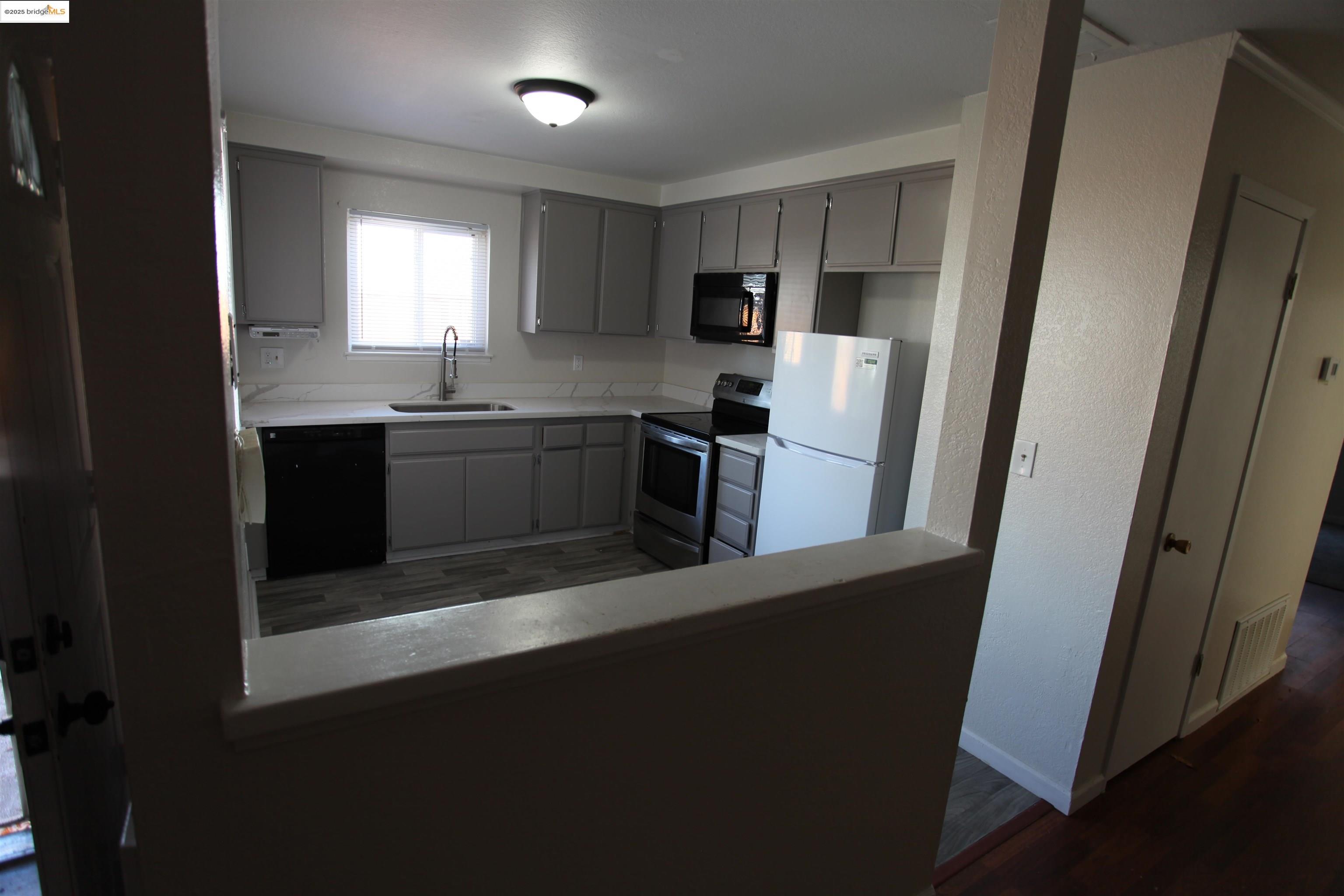 3044 Winterbrook Drive Bay Point, CA 94565 - Photo 5 of 18 a kitchen with kitchen island granite countertop a refrigerator a sink a stove top oven a sink and dishwasher