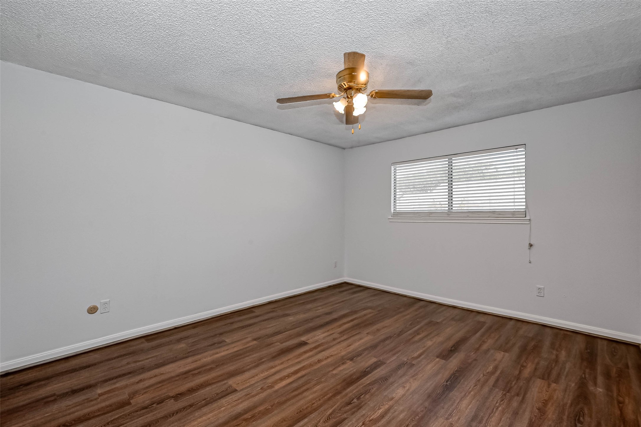 14179 Misty Meadow Lane Houston, TX 77079 - Photo 28 of 41 a view of a room with wooden floor and ceiling fan