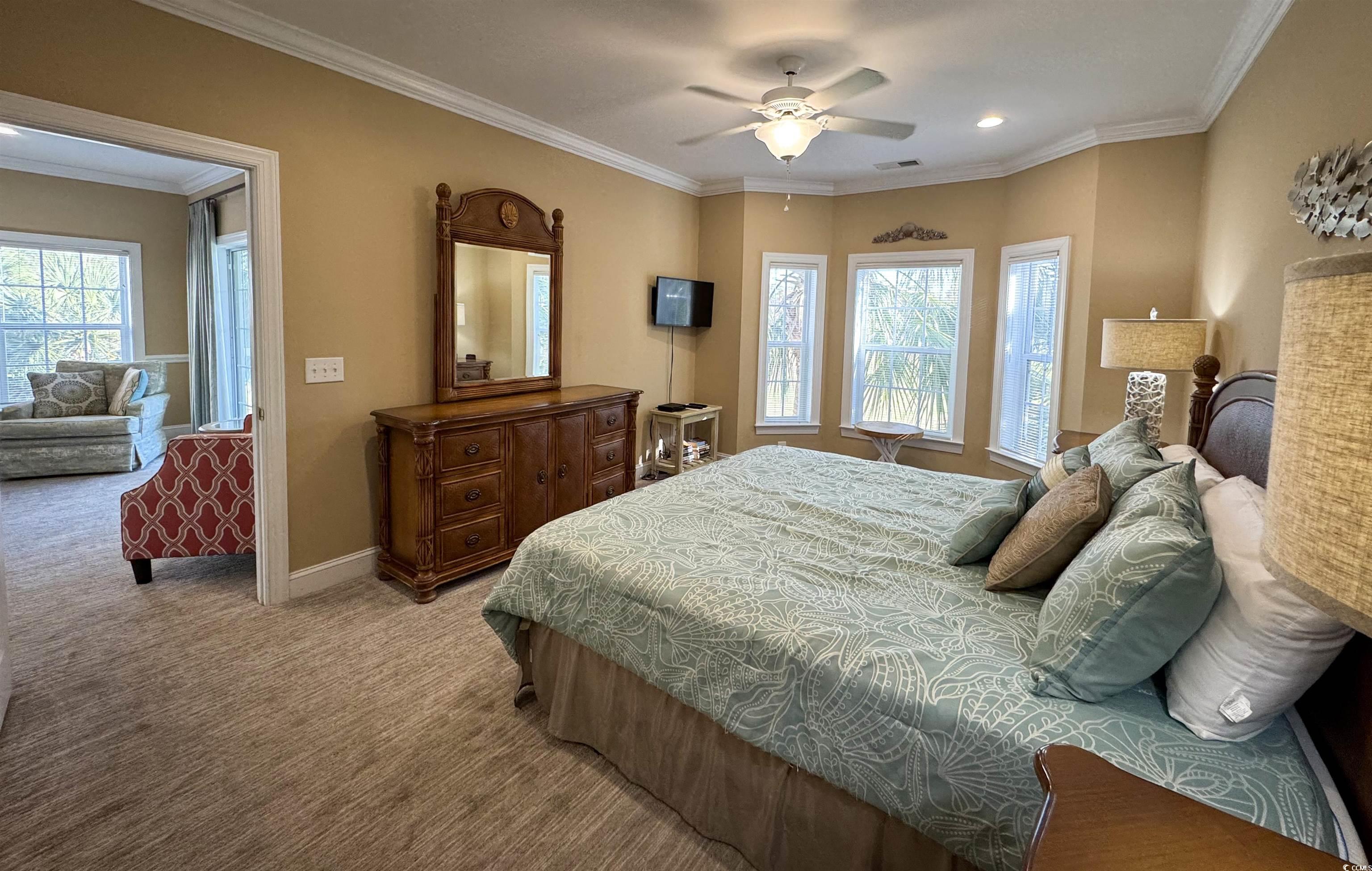 1004 Ray Costin Way, Unit 206 Murrells Inlet, SC 29576 - Photo 11 of 29 Carpeted bedroom with ceiling fan, multiple windows, and ornamental molding
