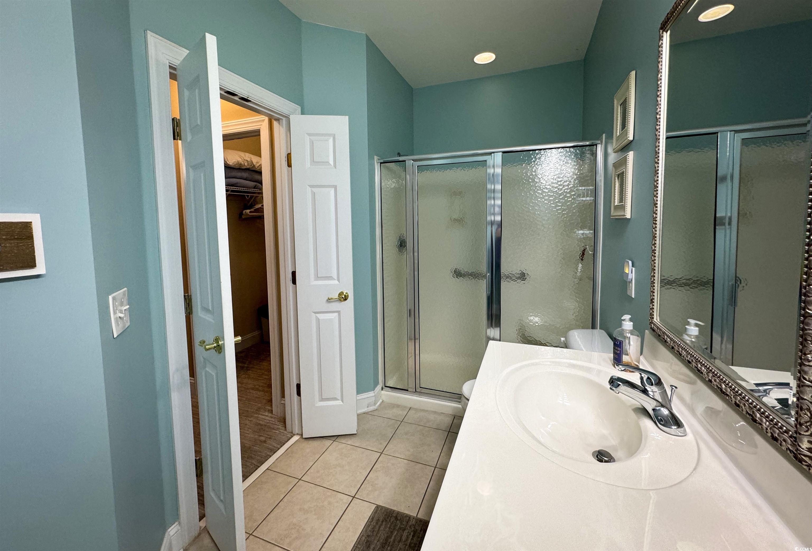 1004 Ray Costin Way, Unit 206 Murrells Inlet, SC 29576 - Photo 13 of 29 Master bathroom with double vanity, tile floor, and spacious shower
