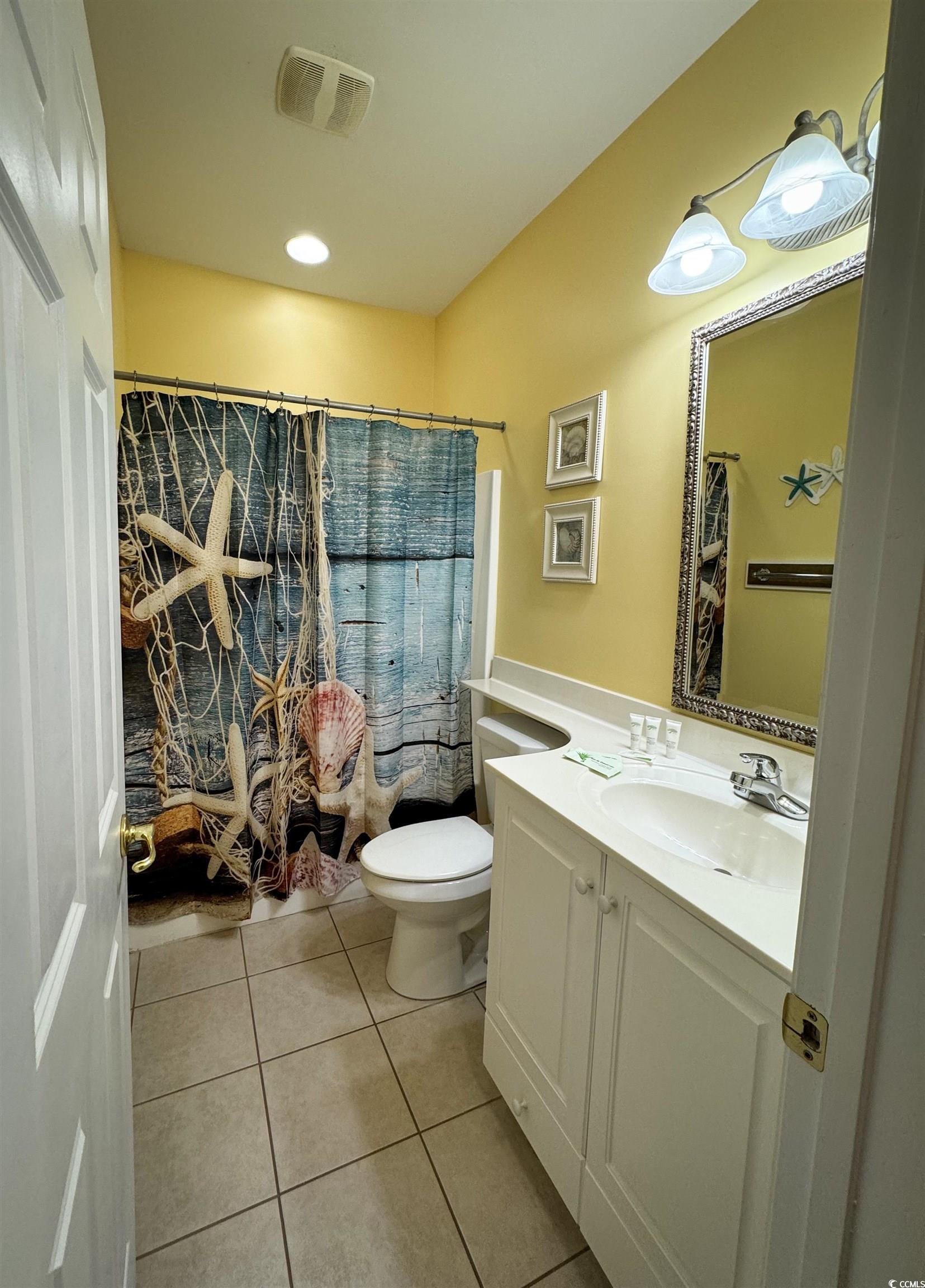 1004 Ray Costin Way, Unit 206 Murrells Inlet, SC 29576 - Photo 16 of 29 Guest bathroom with tile floors and vanity.