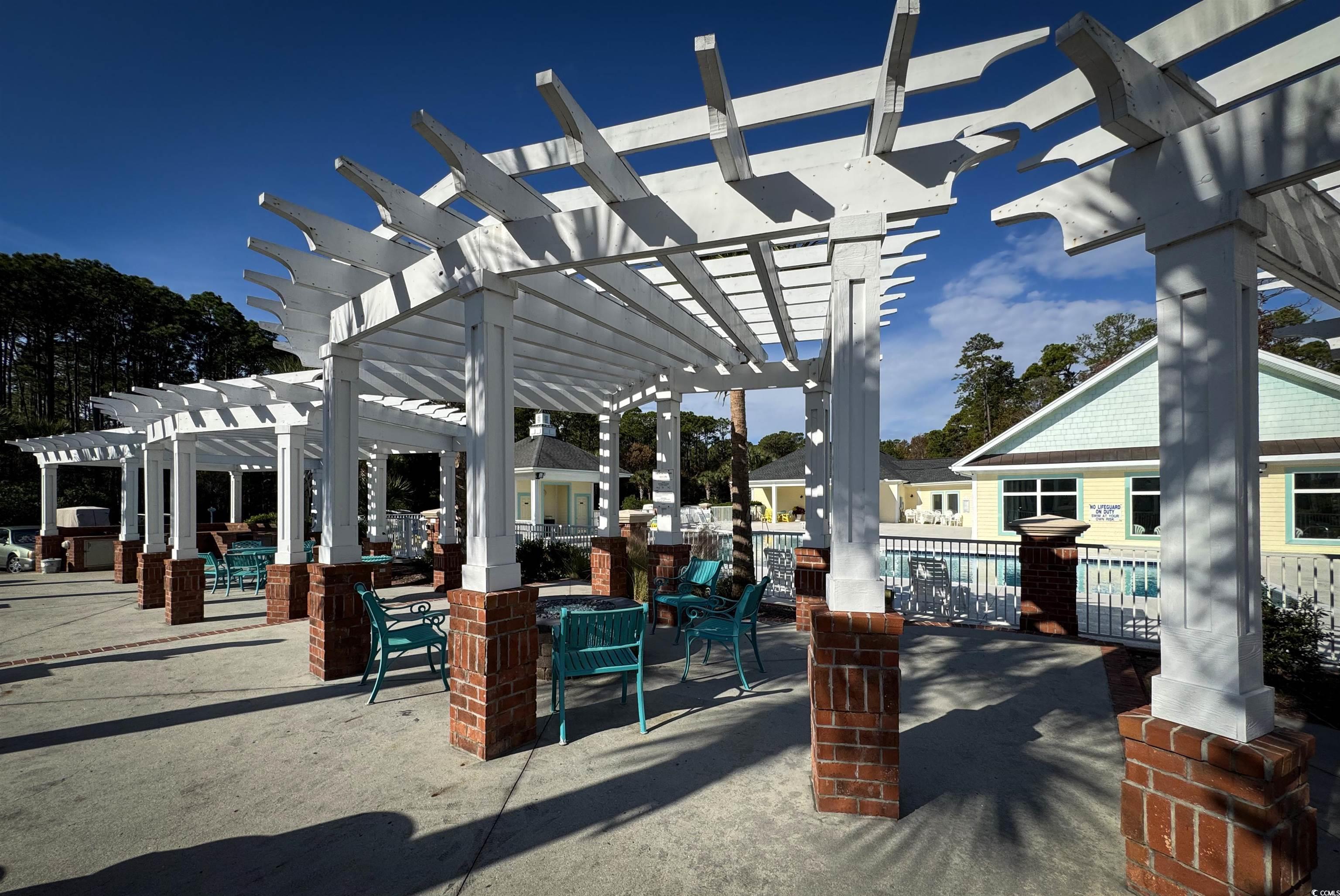 1004 Ray Costin Way, Unit 206 Murrells Inlet, SC 29576 - Photo 25 of 29 View of patio / terrace featuring a pergola for shade while grilling and entertaining.